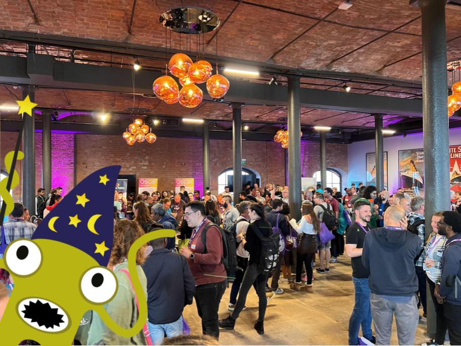 A big crowd of people networking in a conference room space.
