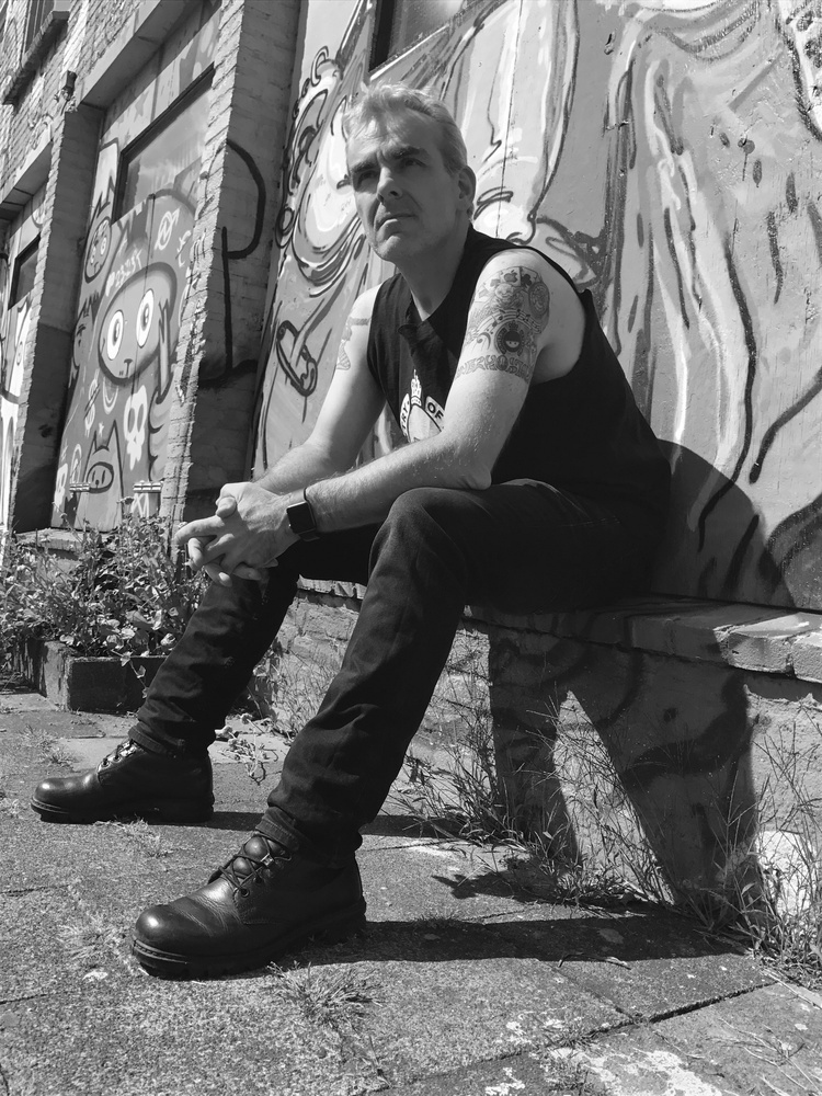 Photo of a man with a Ministry of Testing logo tattoo on his left arm